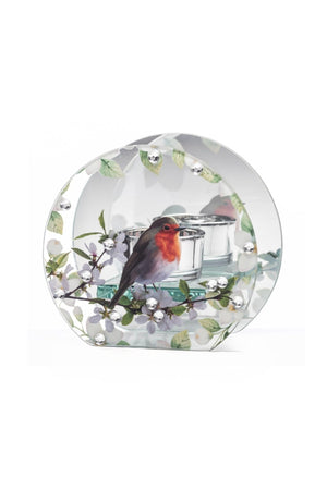 A clear glass decorative candle holder featuring a painted robin bird perched on a flowering branch, with a small glass candle in the center, shown on a white background.
