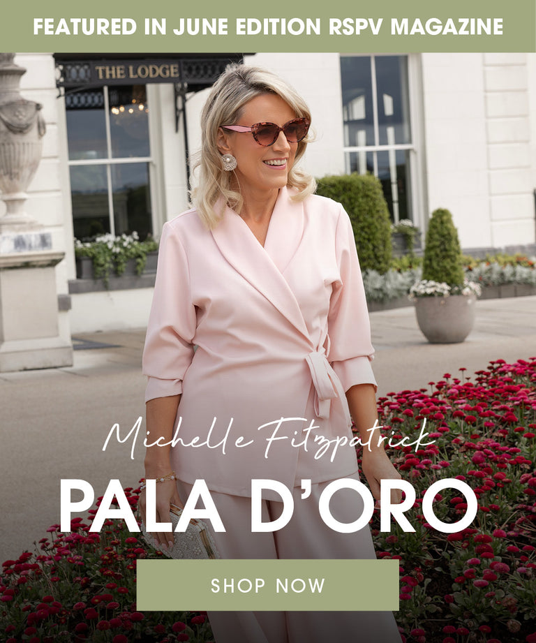 Woman in pink outfit standing in front of a building with 'Pala d'Oro' branding.