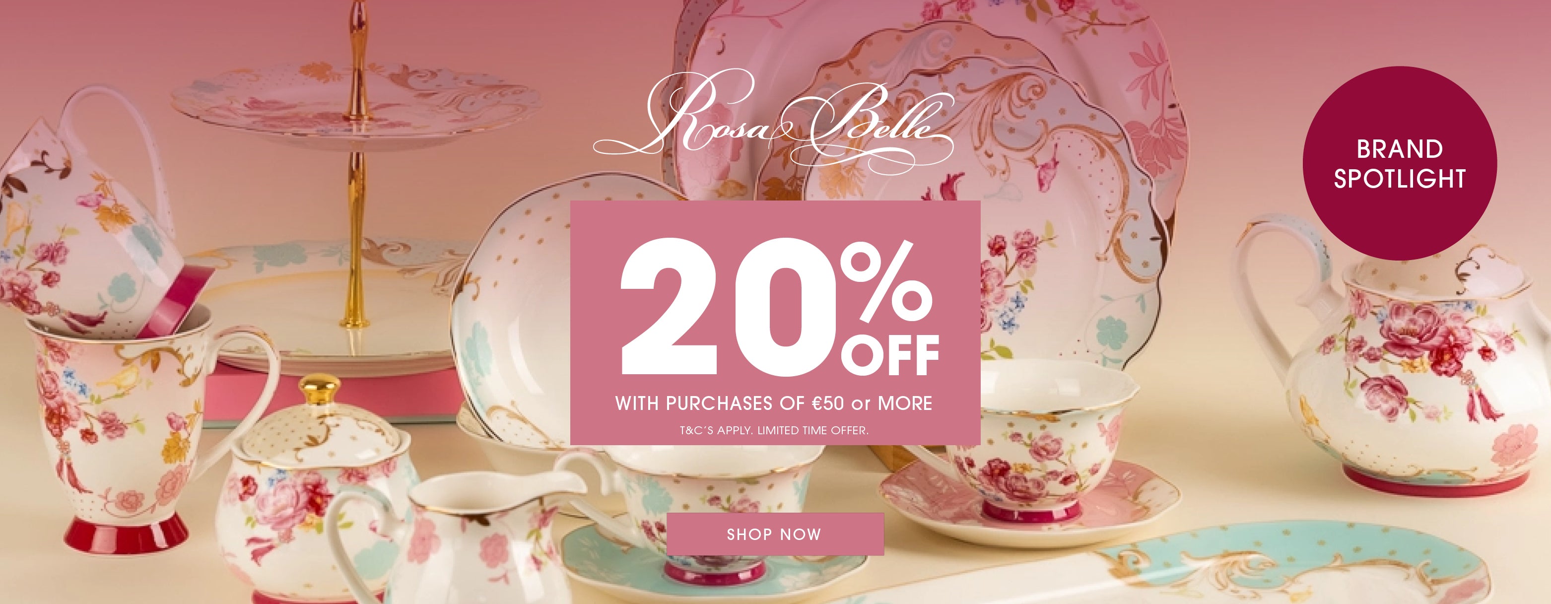 A promotional banner for 'Rosa belle' showcasing a collection of floral teacups, teapots, and serving dishes in pink, red, and blue floral patterns. A large central pink badge advertises a '20% OFF' discount with a 'SHOP NOW' button.