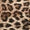 Close-up of a leopard print fabric pattern with black and dark brown spots on a warm beige background.