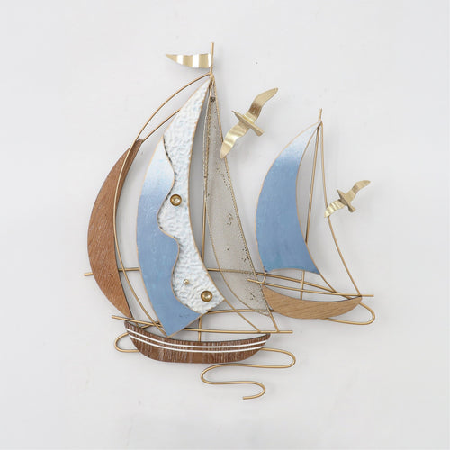 Decorative wall art of a sailboat with blue and brown sails on a white background