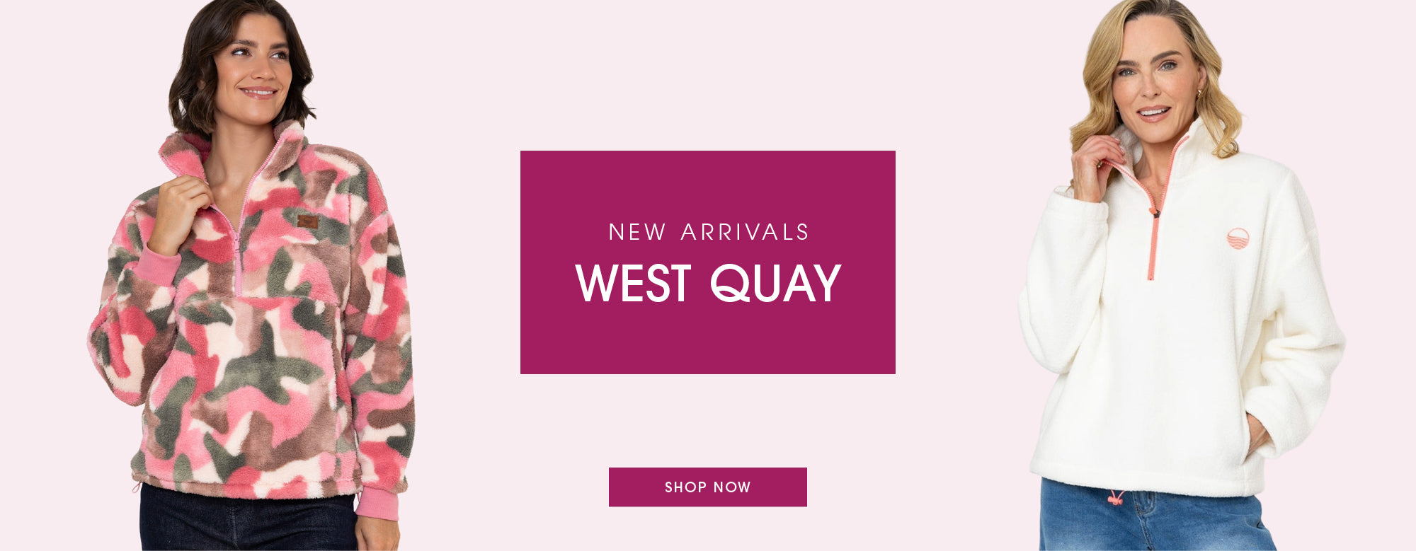 A promotional banner for West Quay featuring two models wearing quarter-zip fleece pullovers. On the left, a model wears a pink, red, and gray camouflage fleece.