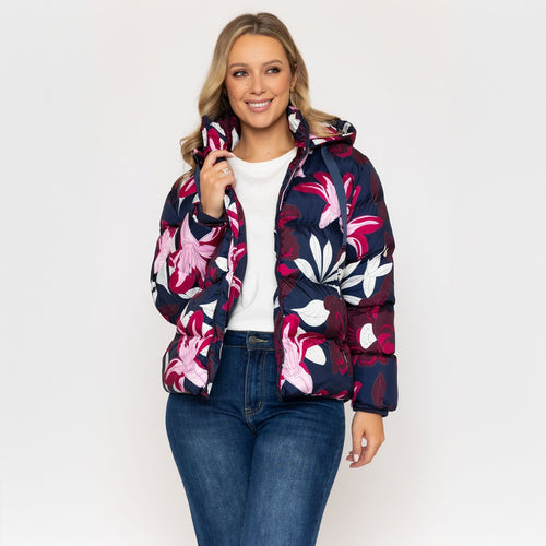 Woman wearing a floral patterned jacket on a white background